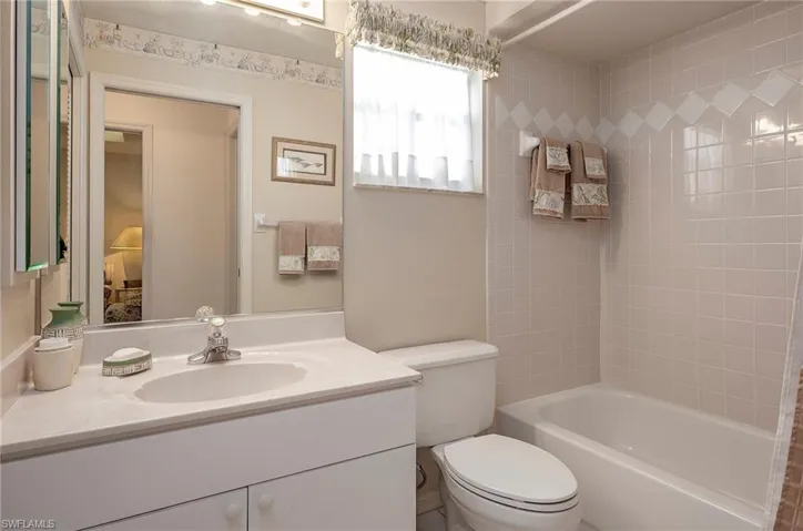 Full bathroom featuring vanity, toilet, and tiled shower / bath combo