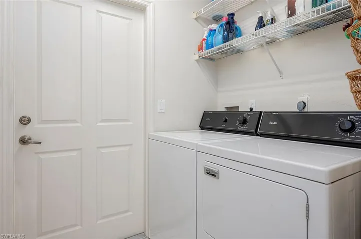Laundry room with separate washer and dryer and pantry opposite to them