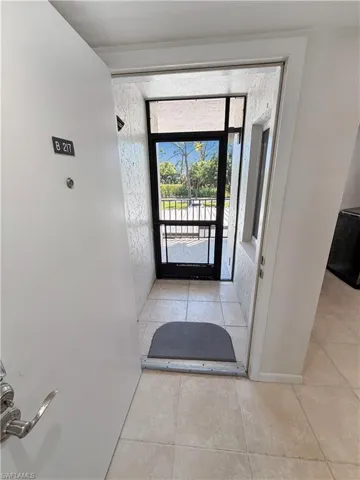 Doorway to outside with tile patterned flooring