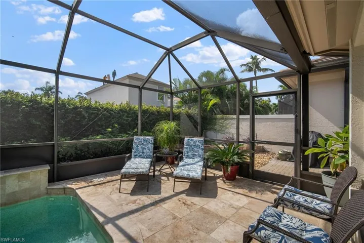 View of patio featuring a lanai