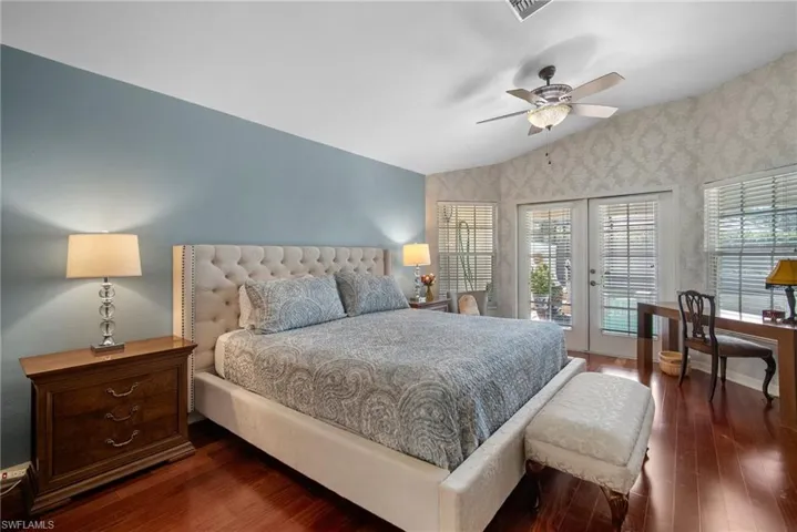 Bedroom with french doors, dark hardwood / wood-style flooring, access to exterior, ceiling fan, and lofted ceiling