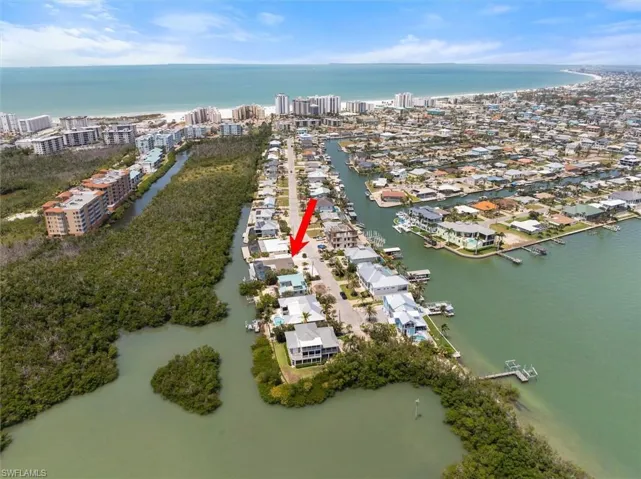 Aerial view of property and surrounding area with a large body of water