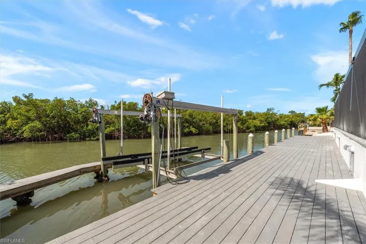 Dock area with boat lift and a water view