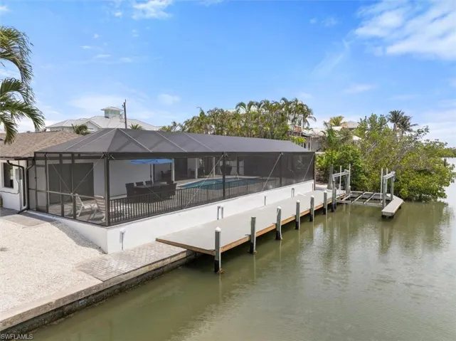 Dock area featuring a water view and glass enclosure