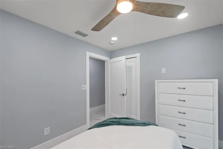 Bedroom with baseboards, light marble finish floors, recessed lighting, and ceiling fan