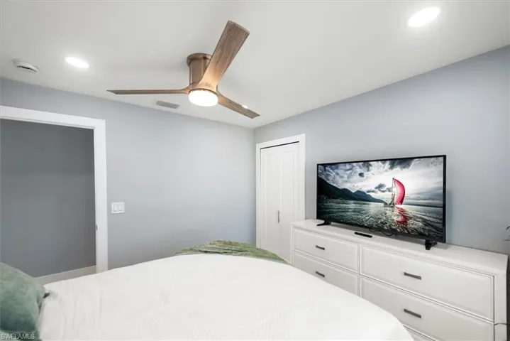 Bedroom with ceiling fan, recessed lighting, and a closet