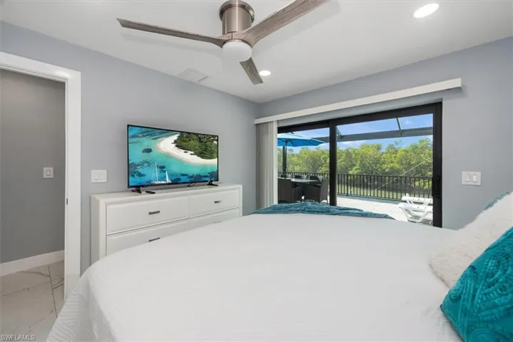 Bedroom featuring light marble finish flooring, access to outside, recessed lighting, baseboards, and a ceiling fan
