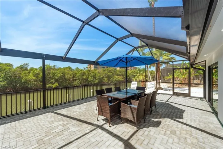 View of patio / terrace featuring glass enclosure and outdoor dining area