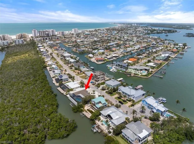 Aerial perspective of suburban area with a nearby body of water