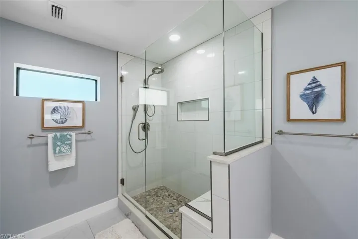 Bathroom with baseboards, walk in shower, marble look tile flooring, and recessed lighting