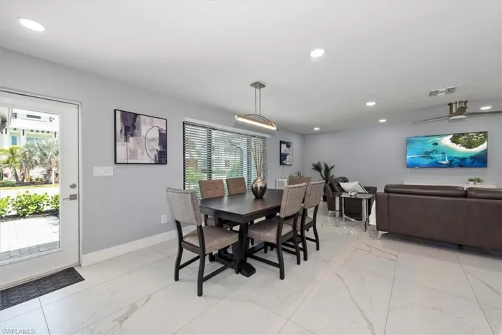 Dining area with light marble finish flooring, recessed lighting, and baseboards