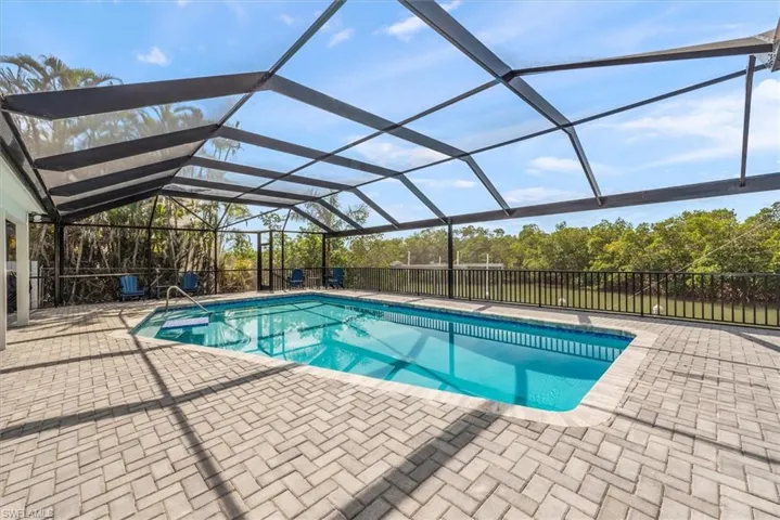 View of pool with a patio area and a lanai