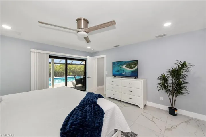 Bedroom with access to outside, light marble finish flooring, baseboards, recessed lighting, and ceiling fan