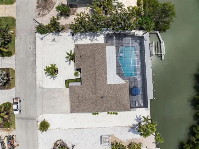 Aerial view of property and surrounding area with a pool area