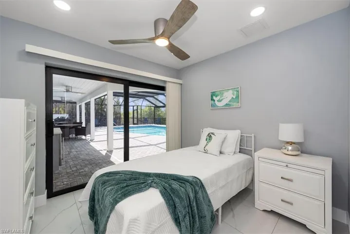 Bedroom featuring light marble finish flooring, access to exterior, recessed lighting, and a ceiling fan