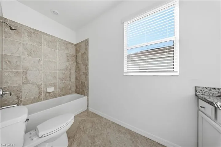 Unfurnished bedroom featuring a spacious closet, light carpet, and crown molding