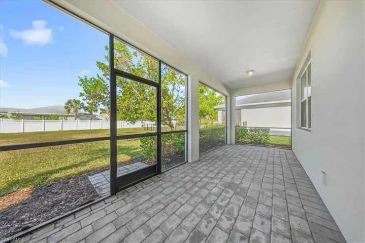 Unfurnished bedroom with light colored carpet and baseboards
