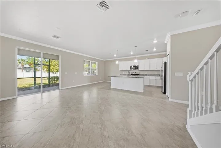 Unfurnished living room with ornamental molding