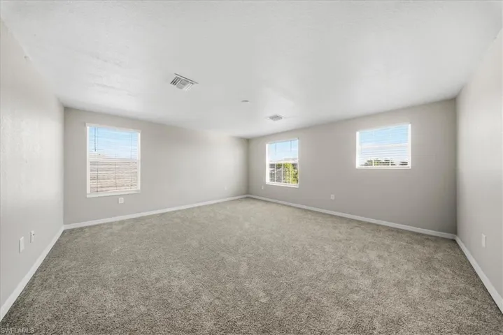 Full bathroom featuring double vanity, a shower stall, crown molding, and a garden tub