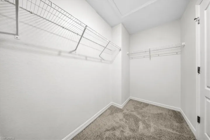 Full bathroom featuring a garden tub, ornamental molding, and a stall shower