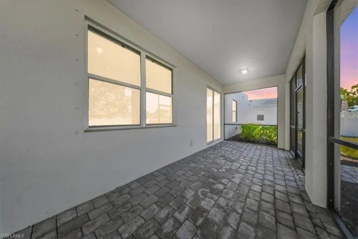 Back of property featuring stucco siding and a sunroom
