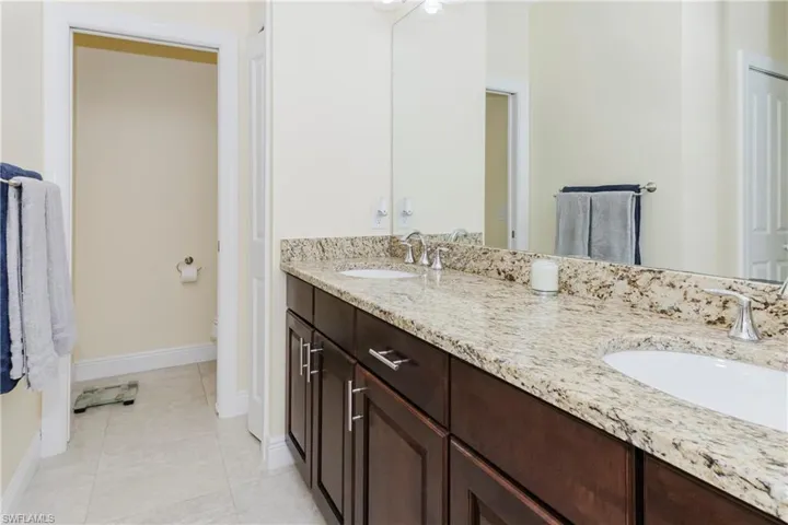 Full bath featuring double vanity, water closet
