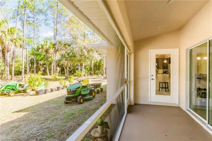 Screened lanai area with slider doors to the living room.