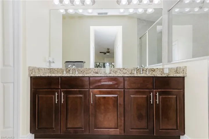 Bathroom with double vanity, an enclosed shower
