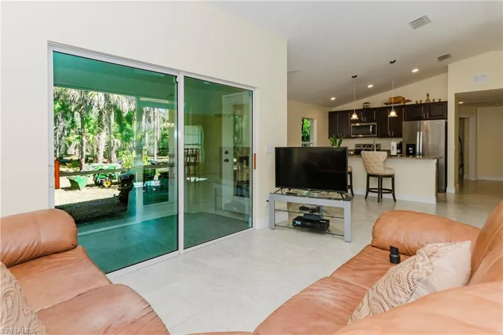 Open living room featuring lofted ceiling.