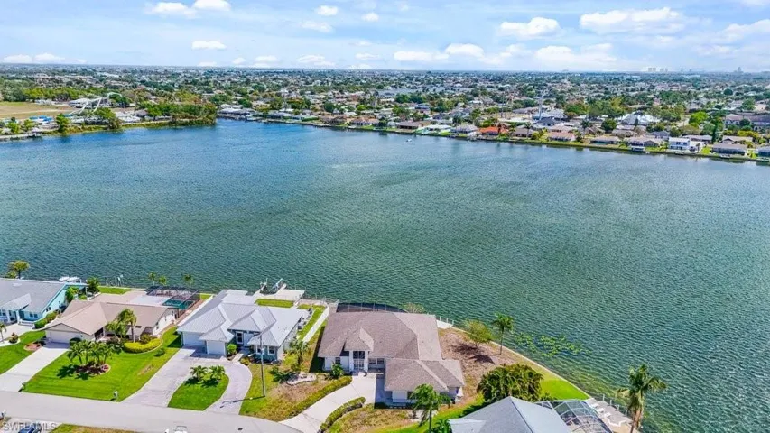 Aerial perspective of suburban area featuring a large body of water