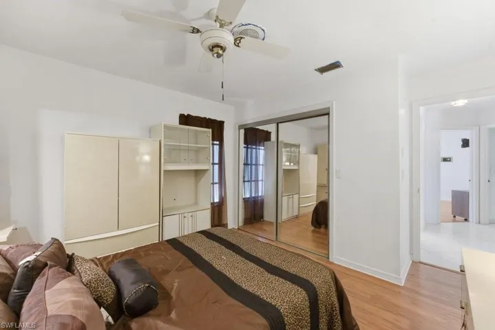 Bedroom featuring ceiling fan, light wood-style floors, and a closet