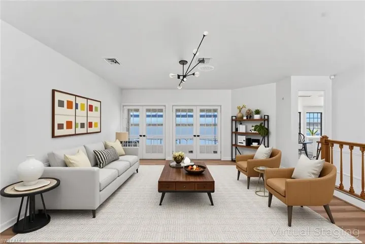 Living room with light wood-type flooring and a chandelier