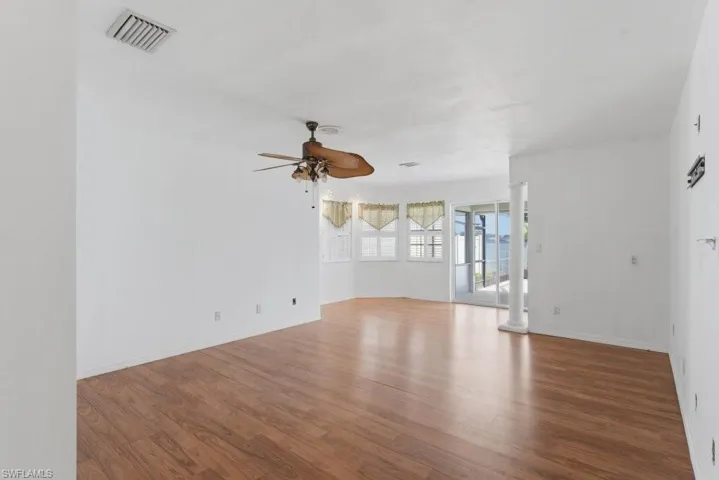 Unfurnished room featuring ceiling fan and wood finished floors