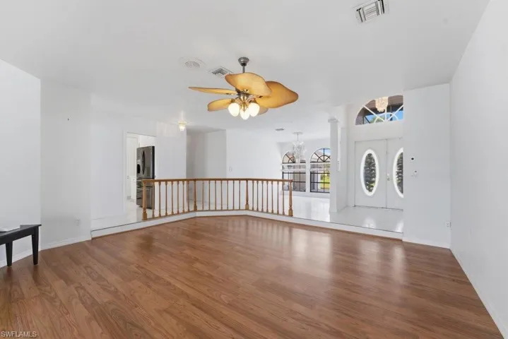 Unfurnished room with wood finished floors and ceiling fan
