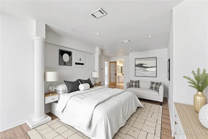 Bedroom featuring light wood-type flooring, ornate columns, and recessed lighting