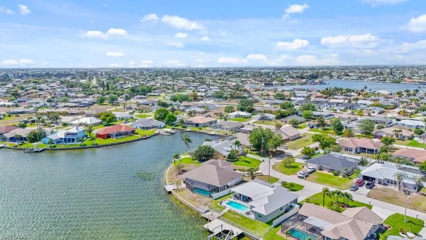 Aerial perspective of suburban area featuring a large body of water
