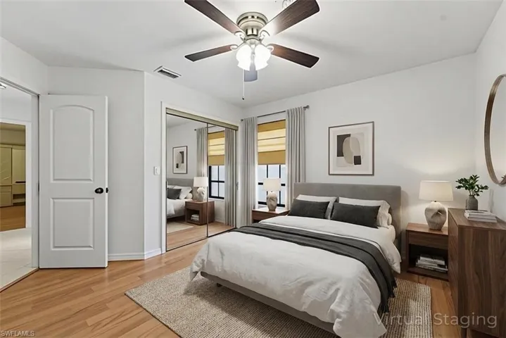 Bedroom featuring light wood finished floors, a closet, and a ceiling fan