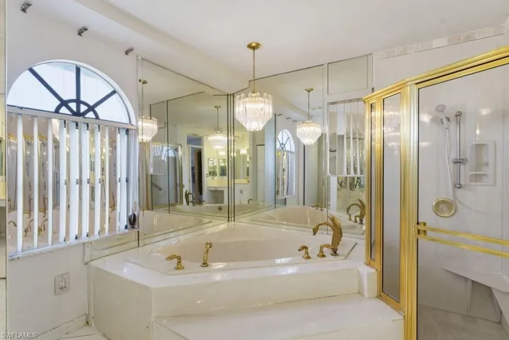 Full bath with a shower stall, a bath, vanity, suspended lighting, and plenty of natural light
