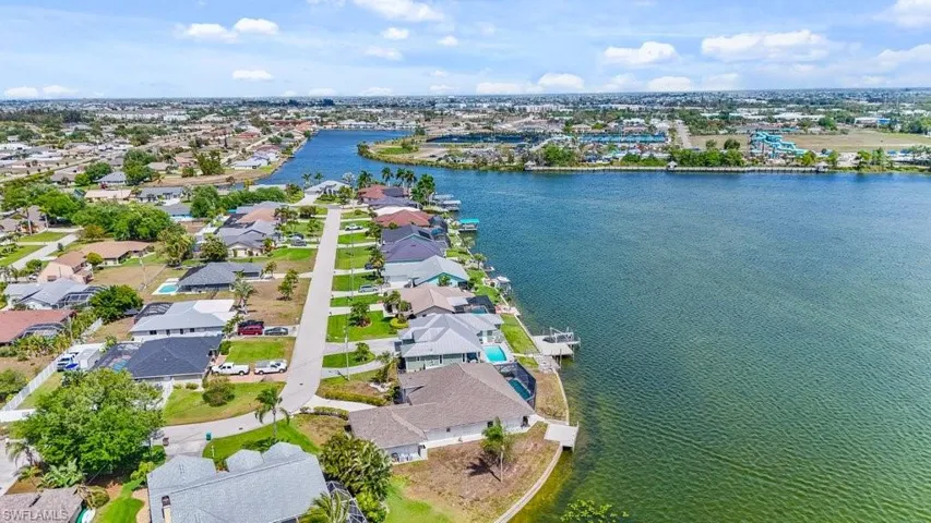 View of property location with a large body of water and nearby suburban area
