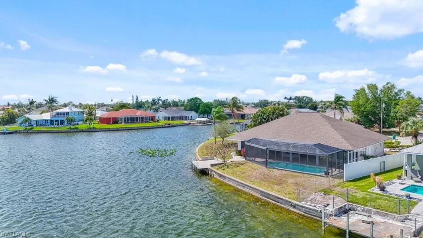 Water view with nearby suburban area and a boat dock