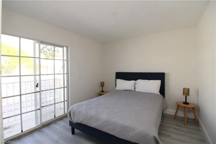 Bedroom with access to exterior and light hardwood / wood-style floors