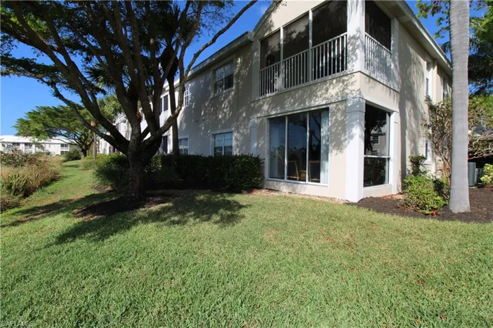 Rear view of property featuring a yard