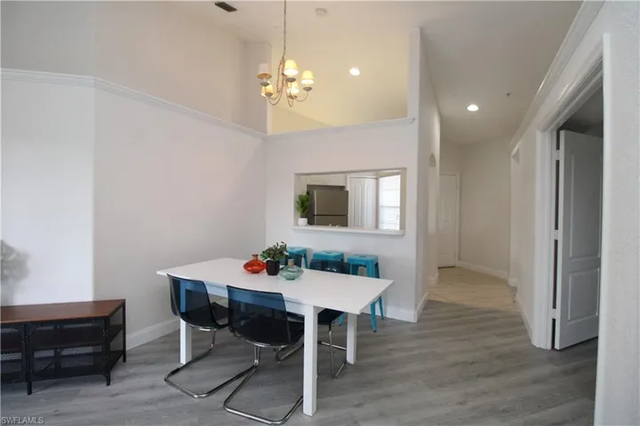 Dining room featuring wood-type flooring, a chandelier, and ornamental molding