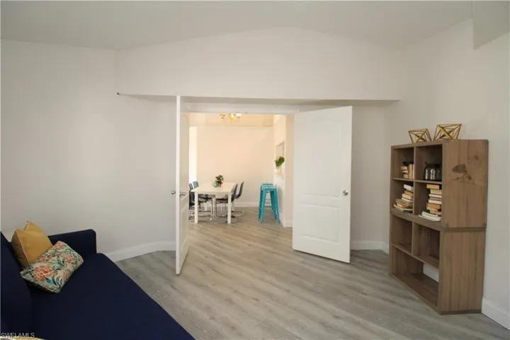 Sitting room featuring light hardwood / wood-style flooring and vaulted ceiling