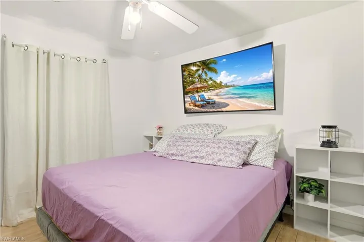 Bedroom with a ceiling fan and light wood-type flooring