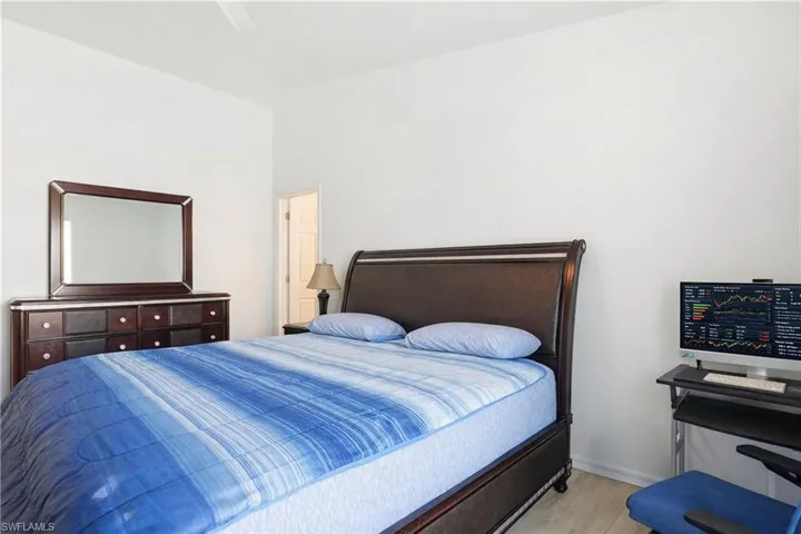 Bedroom with light wood-style floors and ceiling fan