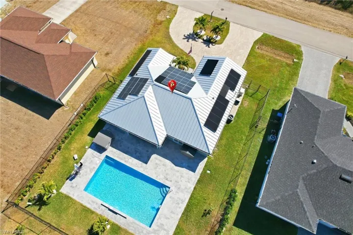 Aerial view of property and surrounding area featuring a pool area