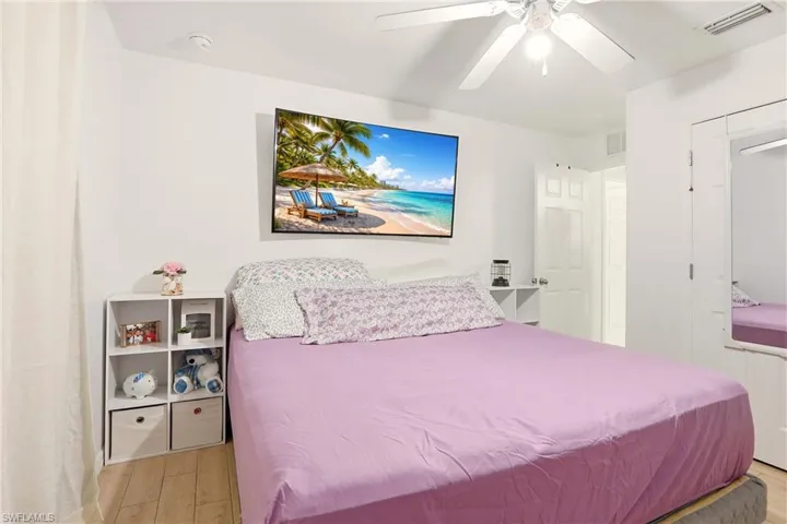 Bedroom with ceiling fan, light wood-type flooring, and a closet