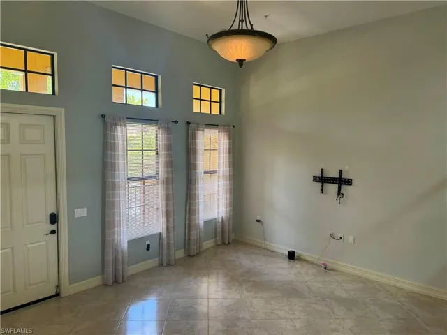 Foyer with a towering ceiling and tile flooring