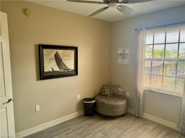 Sitting room with ceiling fan and light hardwood / wood-style flooring